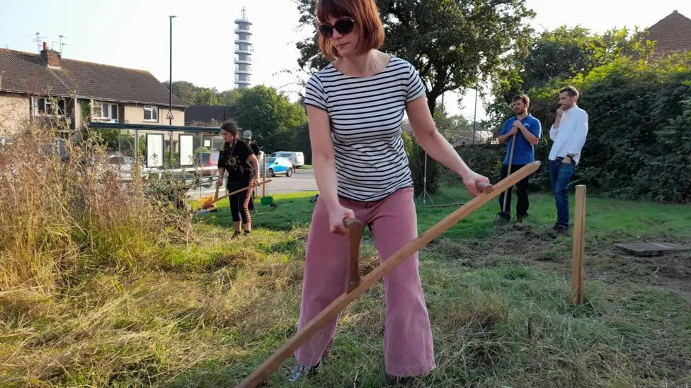 Residents and volunteers scything the meadow at Stanfield Close / Photo : Lockleaze Neighbourhood Trust